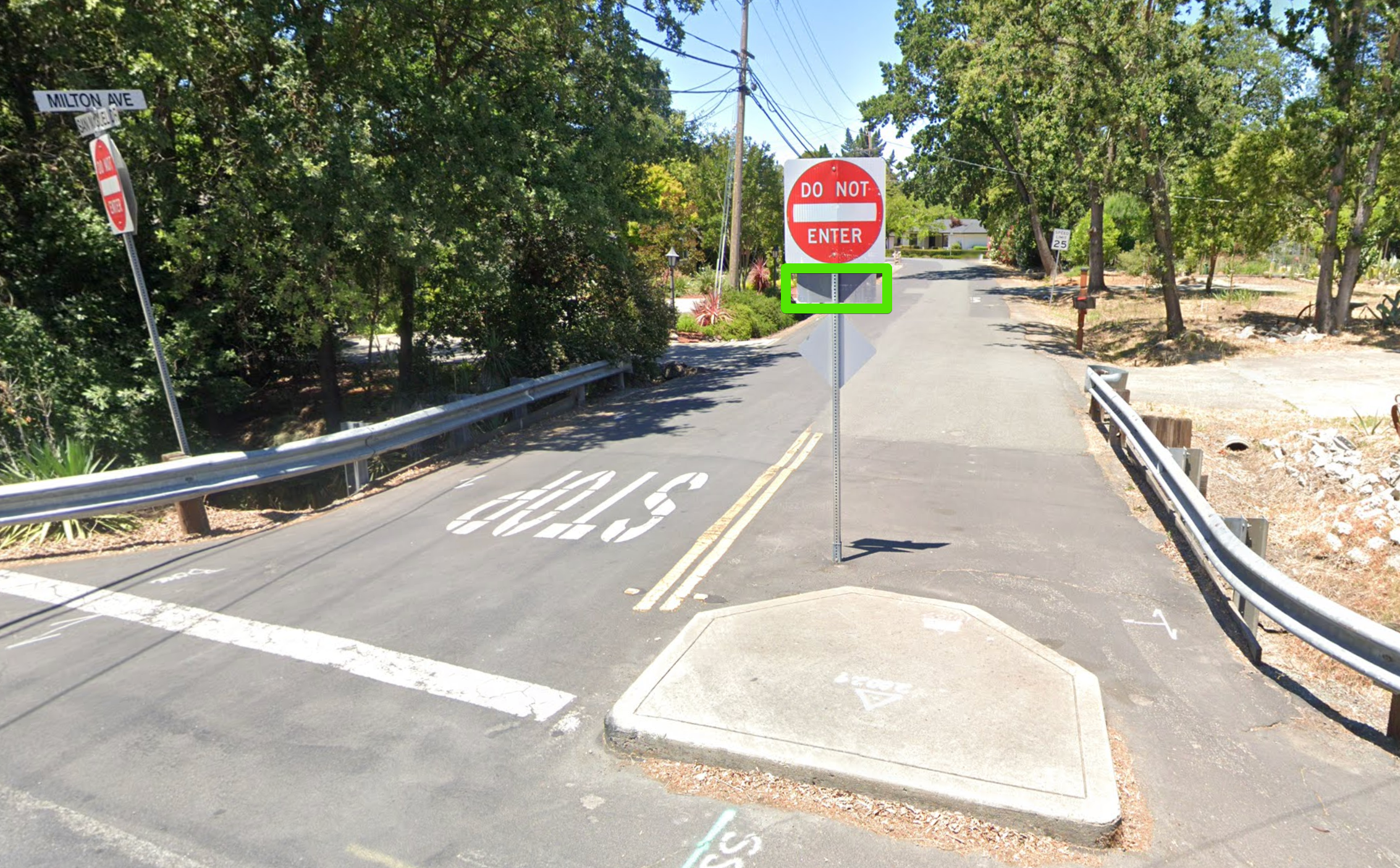 The intersection of Milton Avenue and San Miguel Drive, where a DO NOT ENTER sign blocks cars but a wide gap remains for people walking and biking